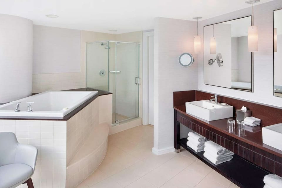 Spacious bathroom with tub, shower, and double sinks