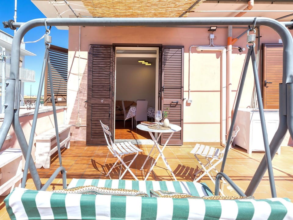 Furniture, Outdoor Furniture, Chair, Shade, Balcony, Sunlounger, Wood Stain, Deck, Umbrella, Vacation