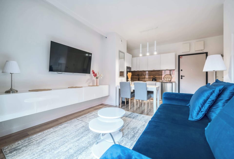 Unwind after a long day in this cozy living room. Sink into the comfortable blue sofa and enjoy your favorite shows on the wall-mounted television.
