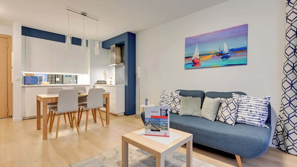 A modern and cozy living area featuring a niebieską sofa and tasteful wall art.