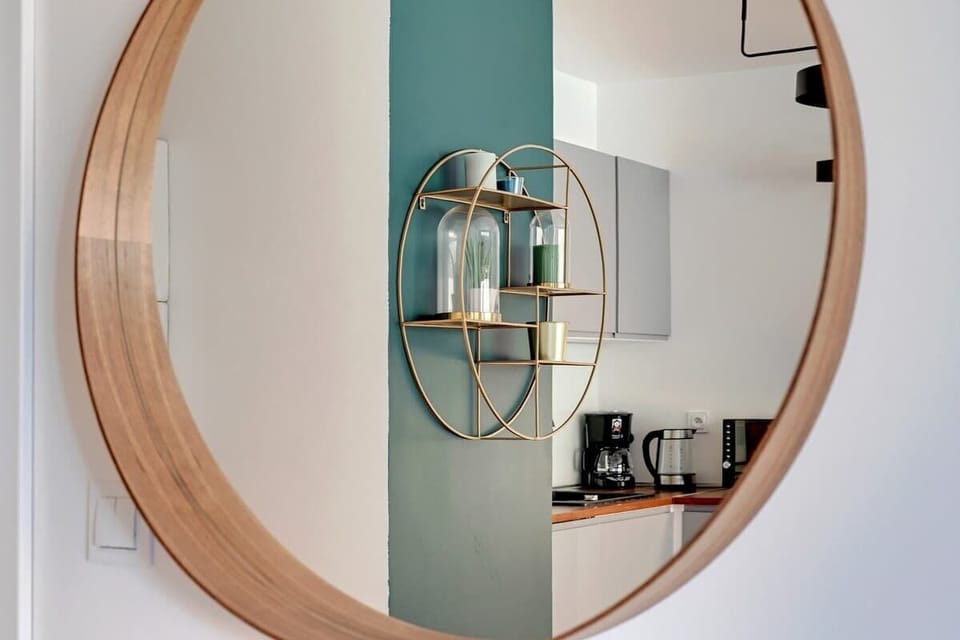 A decorative mirror in the hallway with a stylish frame, adding a modern touch.
