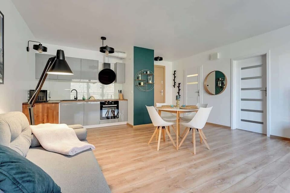 The stylish kitchen, complete with white cabinets, wooden countertops, and fully equipped appliances.