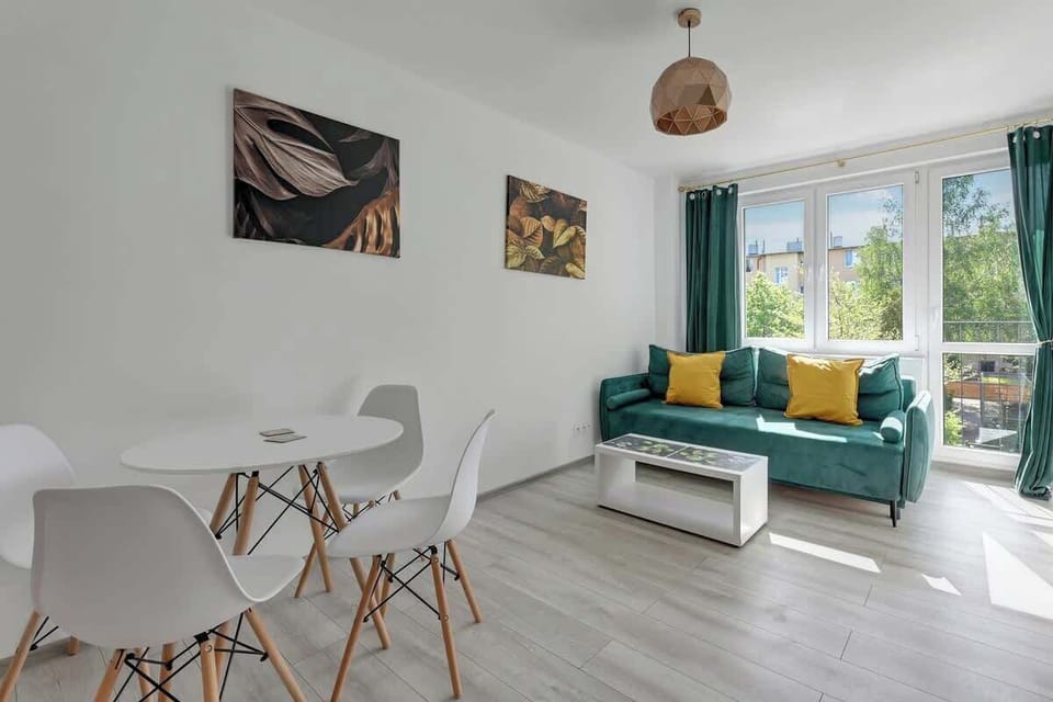 Spacious living room offers comfort and style with an elegant sofa, modern coffee table, and dining set. 
