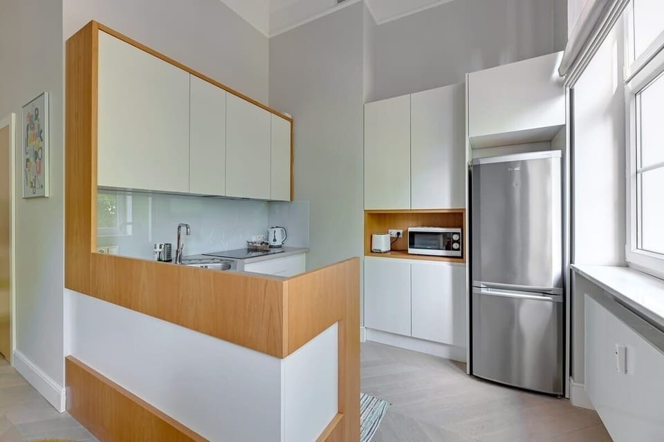 The centerpiece is a practical kitchen island, surrounded by stylish, bright furniture. Superb appliances - from the cooktop to the microwave - make cooking comfortable.