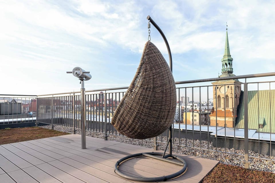 Bright rooftop deck with a view of historic landmarks. Stylish and peaceful for leisure or photos.