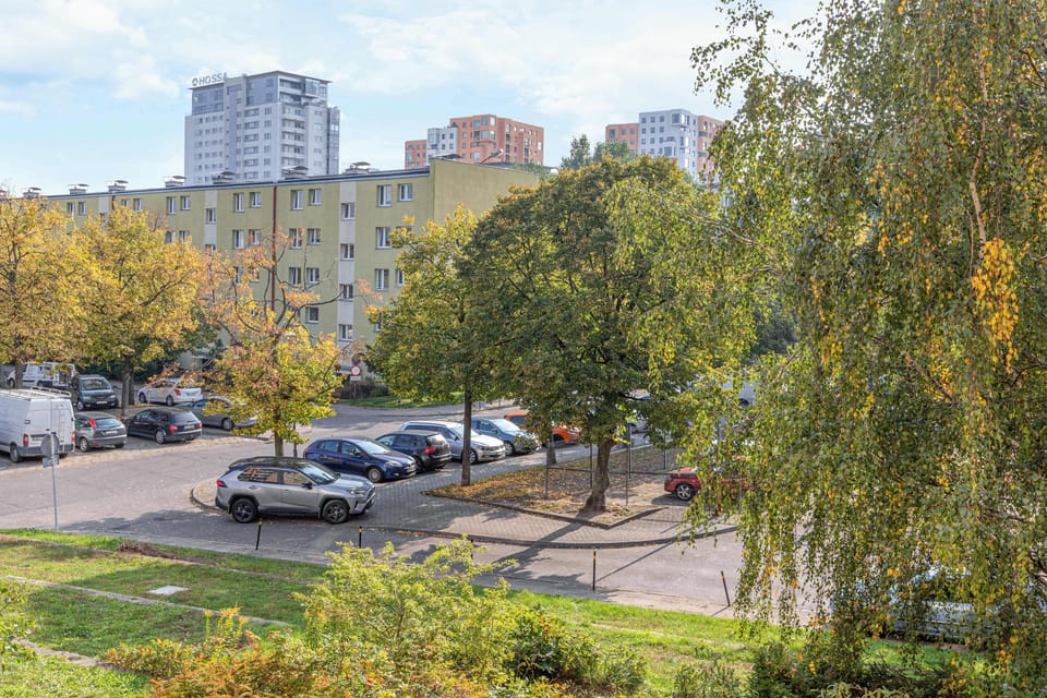 Another exterior shot showing a nearby street with ample public parking. The area is tree-lined, adding to the neighborhood's serene vibe.