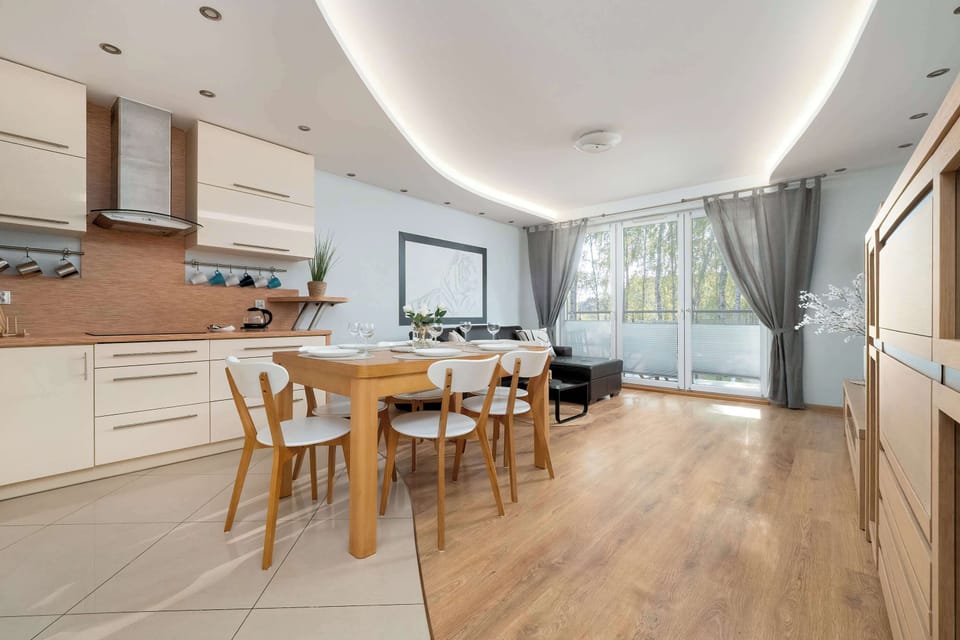 A bright dining area with a large table offers a pleasant setting for meals in natural light.

