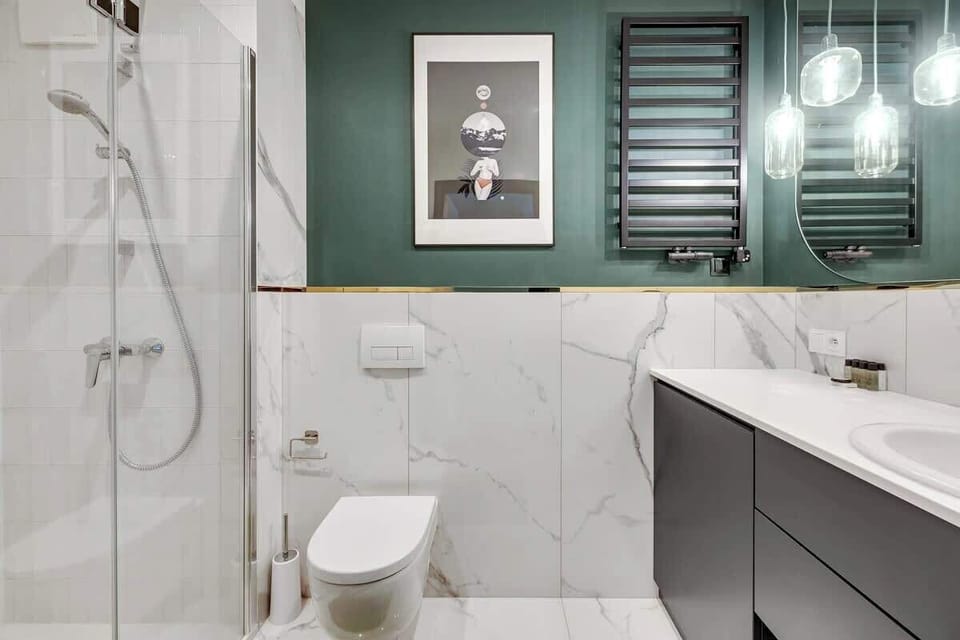 Contemporary elegance, blending luxurious marble textures, rich green accents, and minimalist, refined fixtures for a lavish yet serene ambiance.