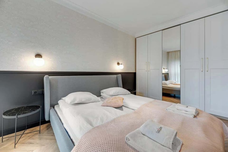 Serene and refined bedroom merges minimalist elegance with subtle sophistication, exuding comfort and timeless charm.