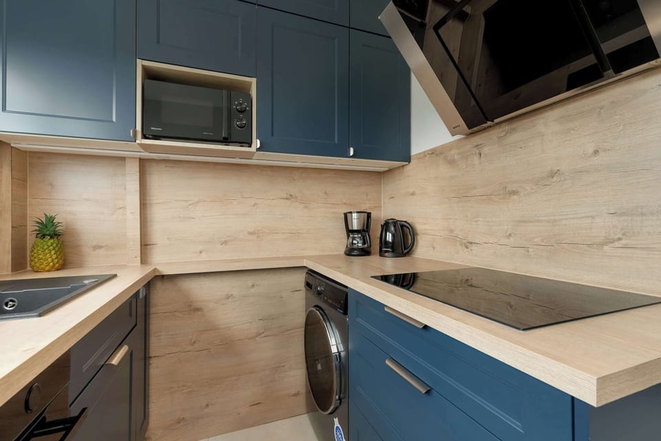 Another angle of the same kitchen with a focus on cabinetry and appliances.