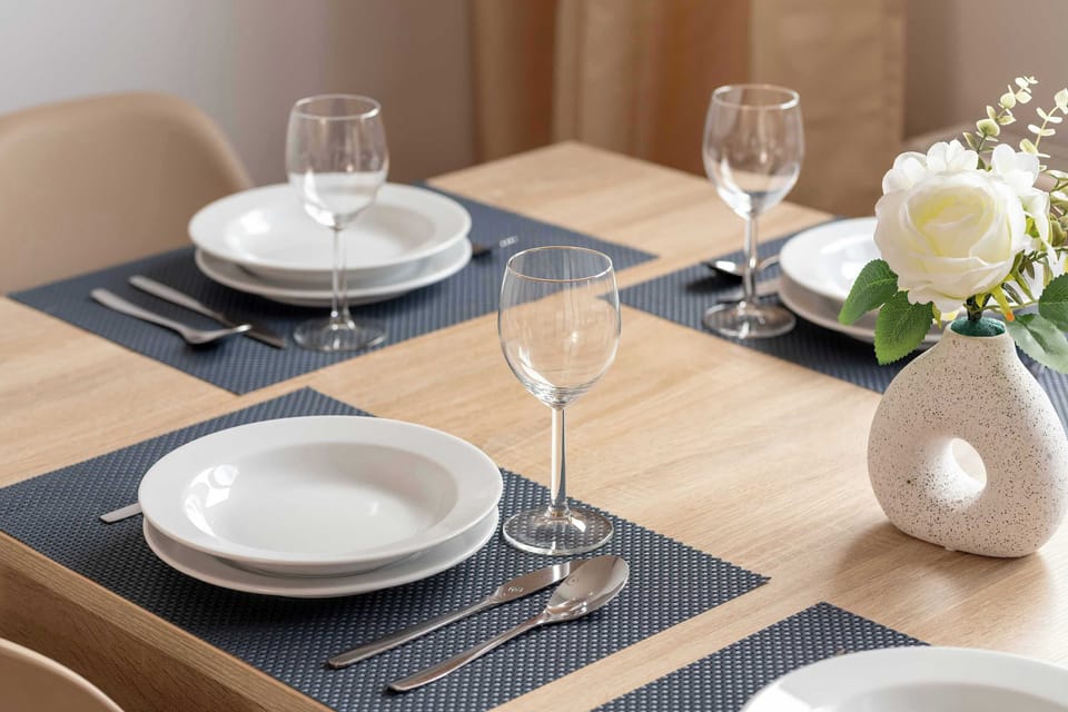 A close-up shot of the dining table beautifully set with flowers and plates.