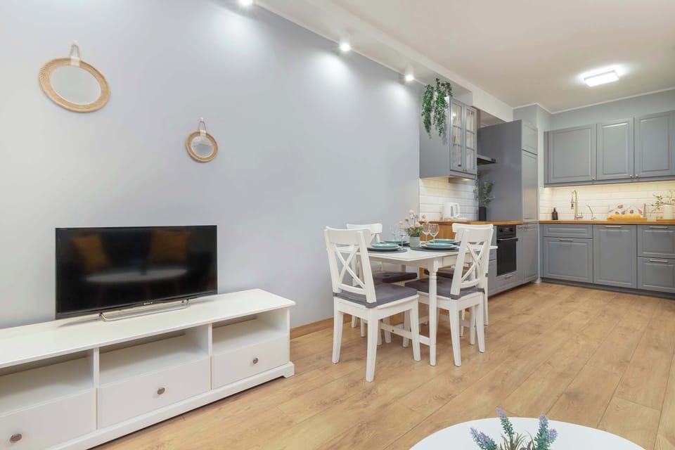  A wider perspective of the living room, showing a dining area in the background.