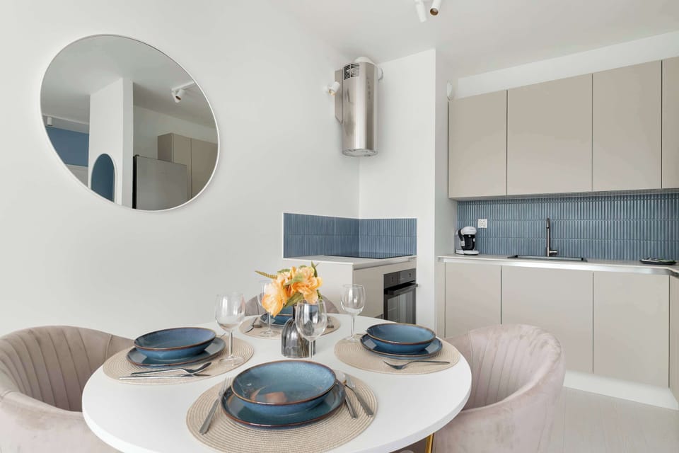 A dining area with a table for four people and modern chairs is perfect for shared meals.