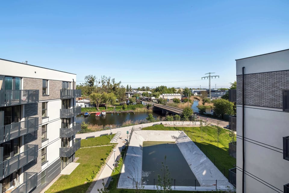 Another view from the balcony showing a wider angle of the courtyard and modern apartment blocks.

