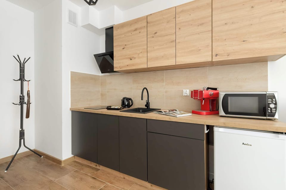 A functional kitchenette offers the essentials for simple meal preparation and coffee making.
