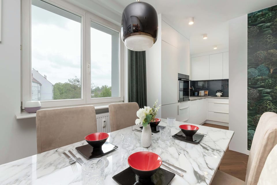 Dining nook with window views and chic tableware set up.