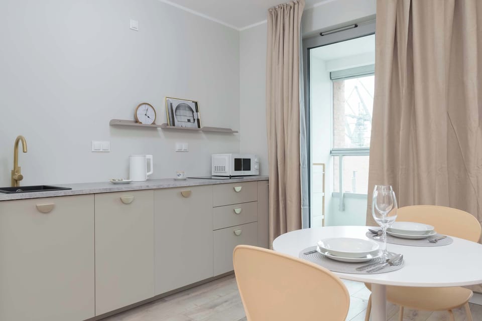 The sleek design of the kitchenette blending seamlessly with the living area.