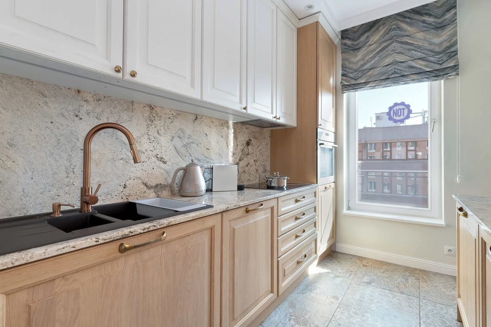 Another view of the kitchen with a focus on the extended countertop and wall-mounted cupboards.

