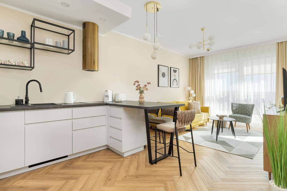 A view of the kitchen and dining area featuring a marble-style tabletop and four elegant upholstered chairs.