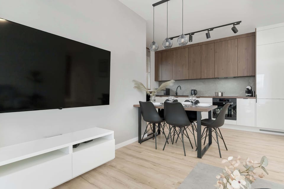 Dining area with kitchenette next to the living room.