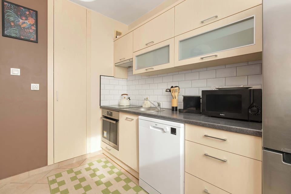Bright kitchen with cooking utensils. 