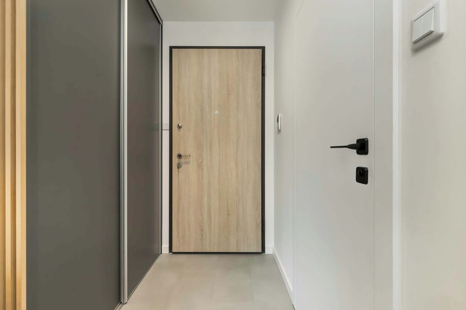  A stylish corridor with doors in a wooden finish.