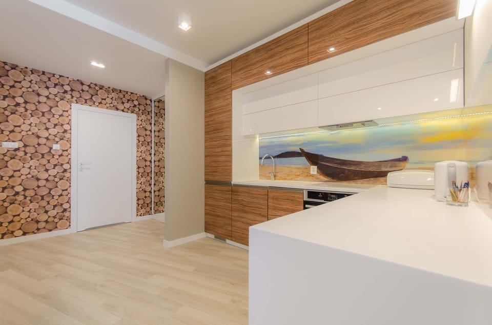 A fully equipped kitchenette with wooden accents and a sleek, modern design.