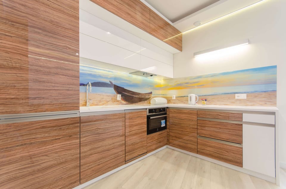 A fully equipped kitchenette with wooden accents and a sleek, modern design.