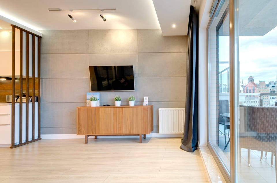 TV in the lounge area and access to balcony.