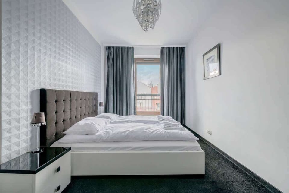 The classic white and gray furniture introduces harmony, while the spacious room makes you feel special. The large window allows plenty of natural light, and minimalist accents highlight the room's elegance.