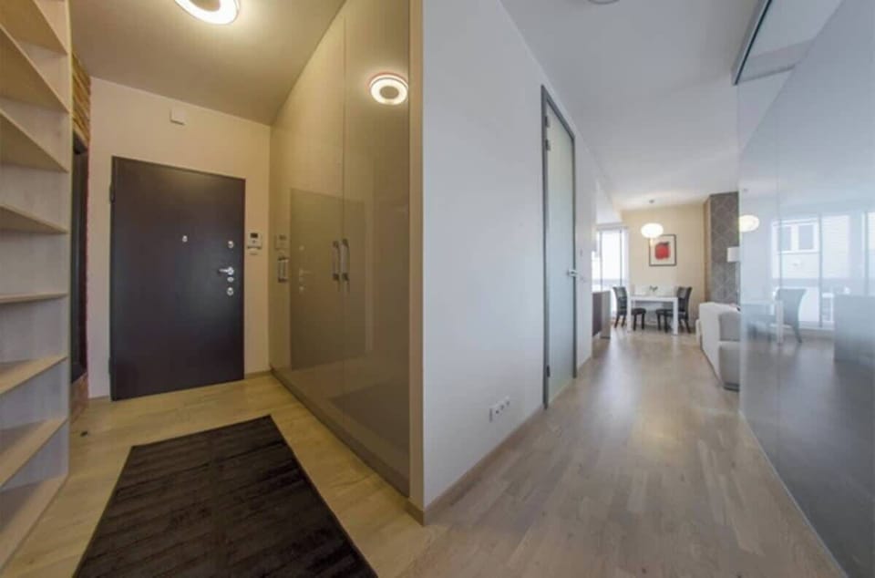 The coziness of the living room is emphasized by spacious hall and a soft rug, making the space feel exceptionally homely.