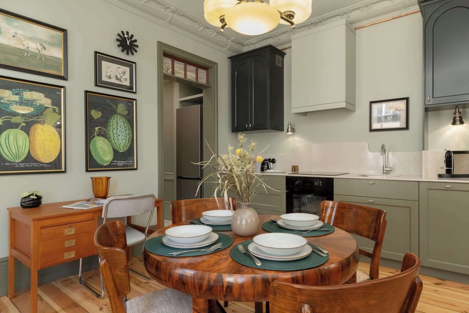 A view of the dining area prepared for a meal, with neatly arranged plates and rustic tableware.