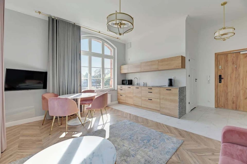 Stylish, airy space blends soft pastel tones with sleek, modern finishes, creating a harmonious atmosphere enriched by elegant gold accents and clean, contemporary furniture.