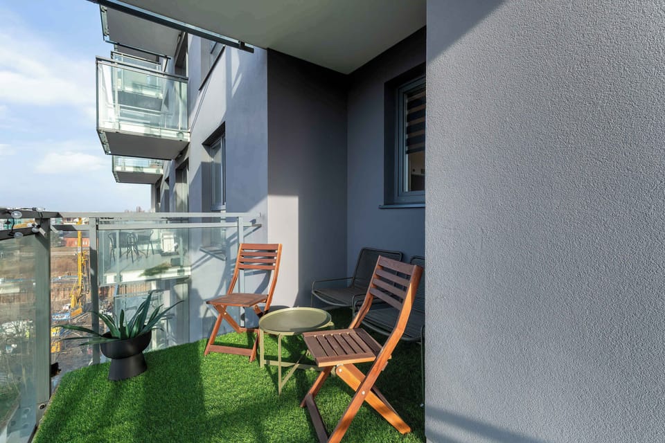 A balcony with two chairs and a small table, perfect for enjoying the outdoor space.