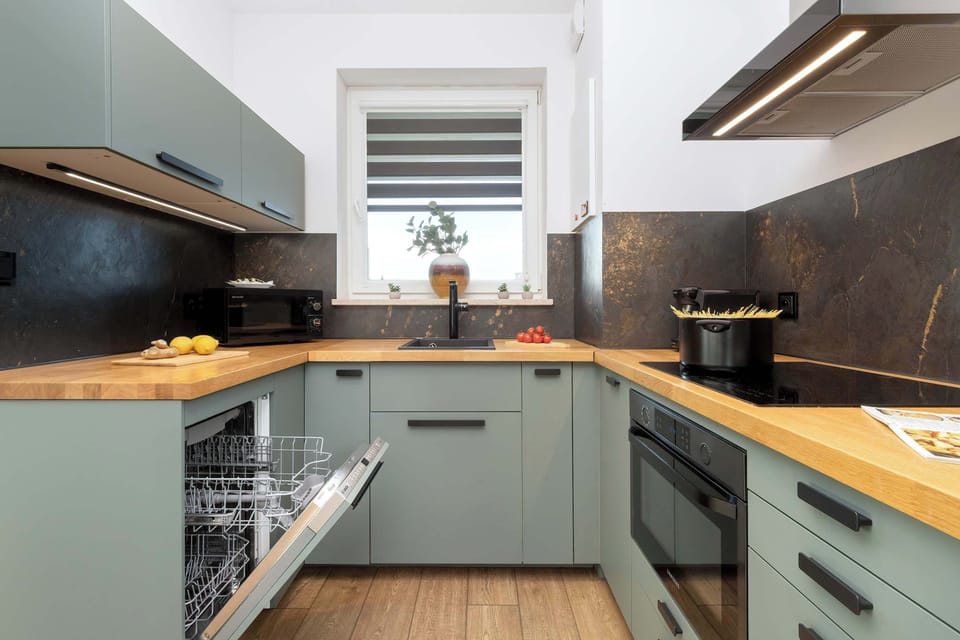 A clean and practical kitchen layout, showcasing its functionality and sleek finishes.