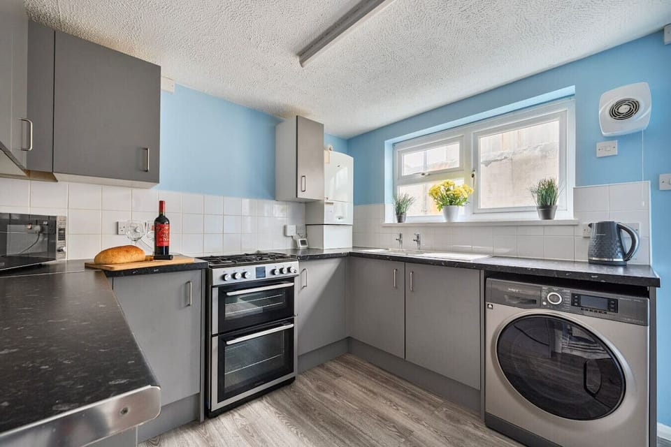 Modern kitchen with washing machine and bright windows