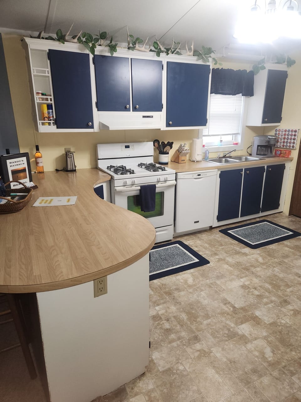 Kithcen with new painted cupboards and updated appliances. The cookstove is gas.