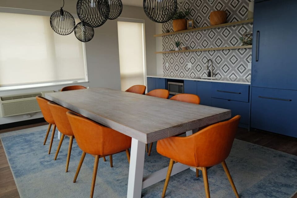 Terrace Dining Room: Gather around the chic table and enjoy meals with stunning city views!
