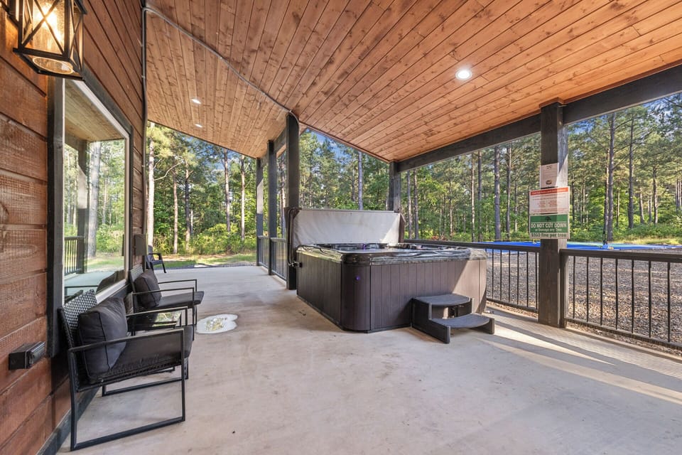 Whether it’s morning coffee or evening soaks, this covered patio with a bubbling hot tub is your front-row seat to the peaceful pines.