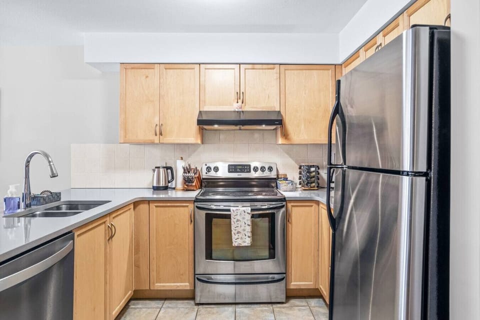 Fully equipped kitchen featuring a breakfast bar with seating for two, perfect for casual meals and morning coffee.
