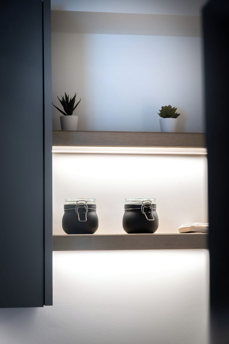 Elegant illuminated shelves with chic decor, perfect for a modern and cosy vibe.