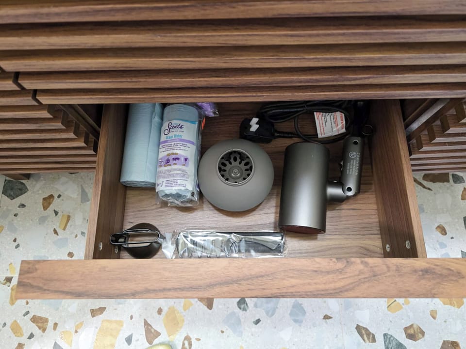 Well-stocked drawer—hairdryer, diffuser, and styling tools included.