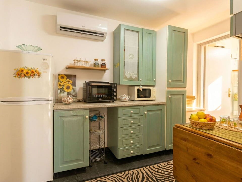 Cabinetry, Furniture, Kitchen, Interior Design, Kitchen Appliance, Countertop, Wood, Major Appliance, Flooring, Cupboard