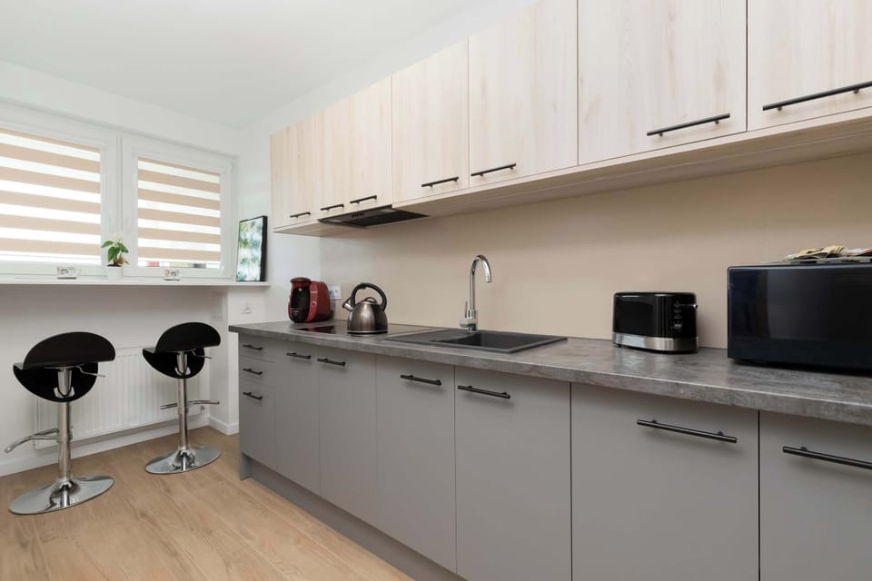 The spacious kitchen with a breakfast island and modern appliances is perfect for cooking together.