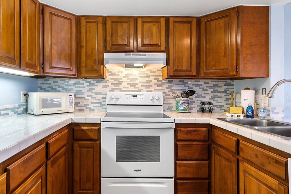 Condo, Multiple Beds, Lanai, Partial Ocean View (White Sands Village 210) | Private kitchen | Full-size fridge, microwave, oven, stovetop