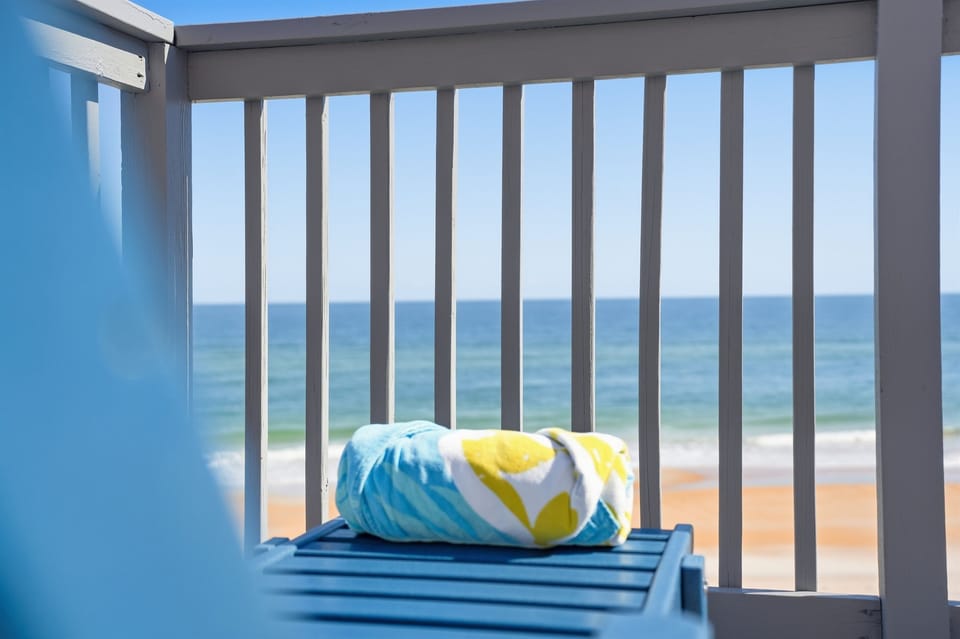 Shaded balcony seating offers a breezy spot to relax while overlooking the water.