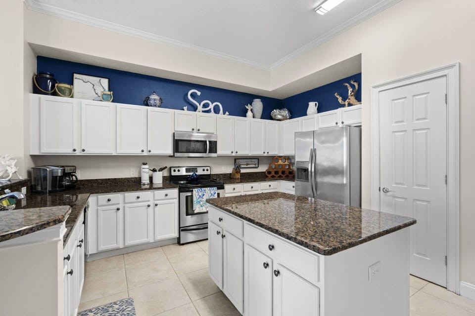 Updated Kitchen with Stainless Steel Appliances and Sleek White Cabinetry
