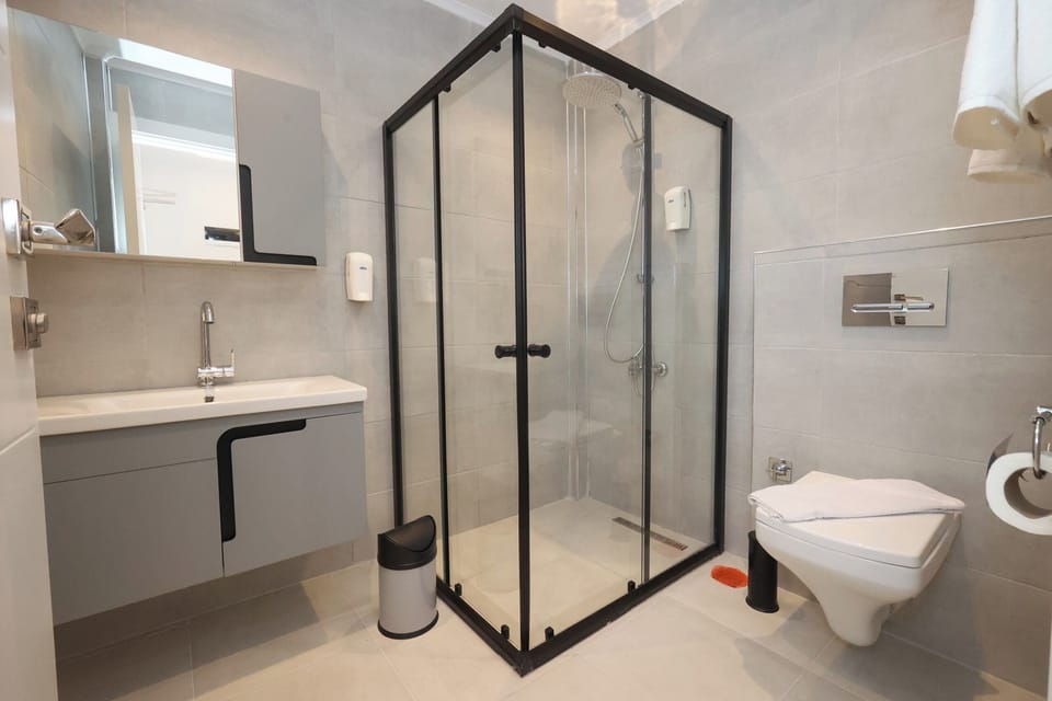 Shower, hair dryer, slippers, towels