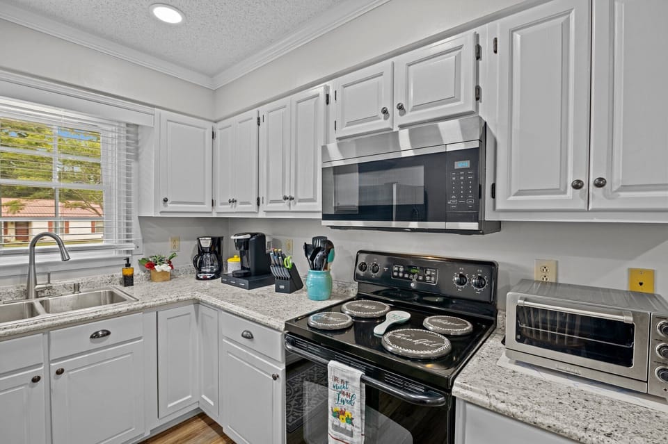 Kitchen includes oven, microwave, toaster, drip coffee maker and Keurig.