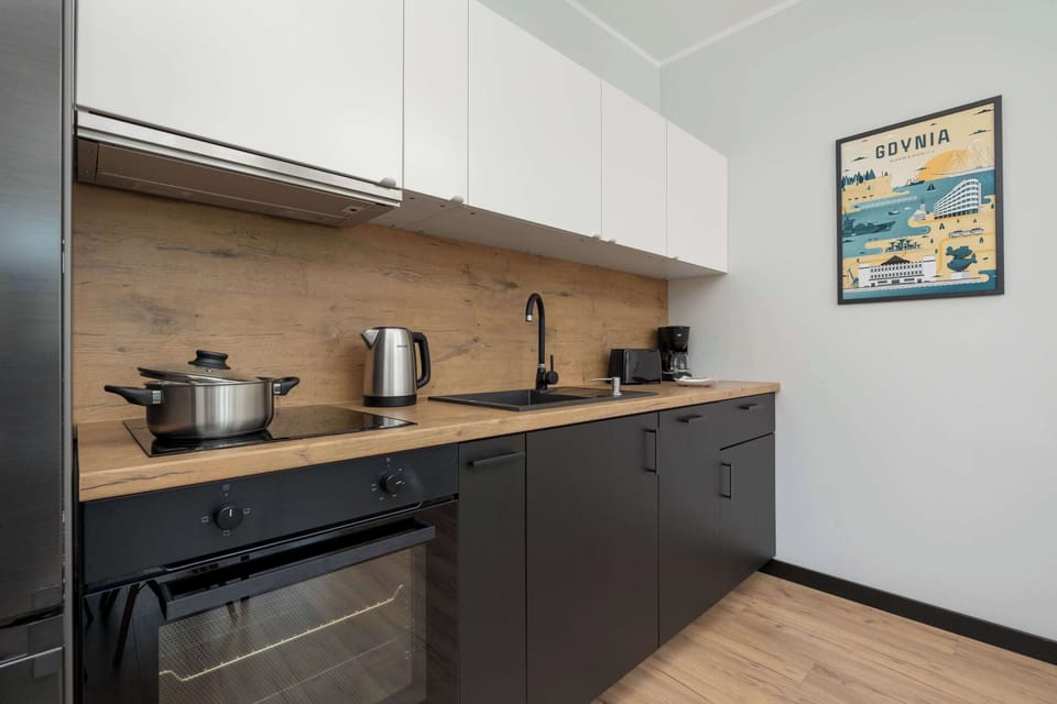 A close-up of a modern kitchen with black cabinetry and built-in appliances. The space is both stylish and functional.